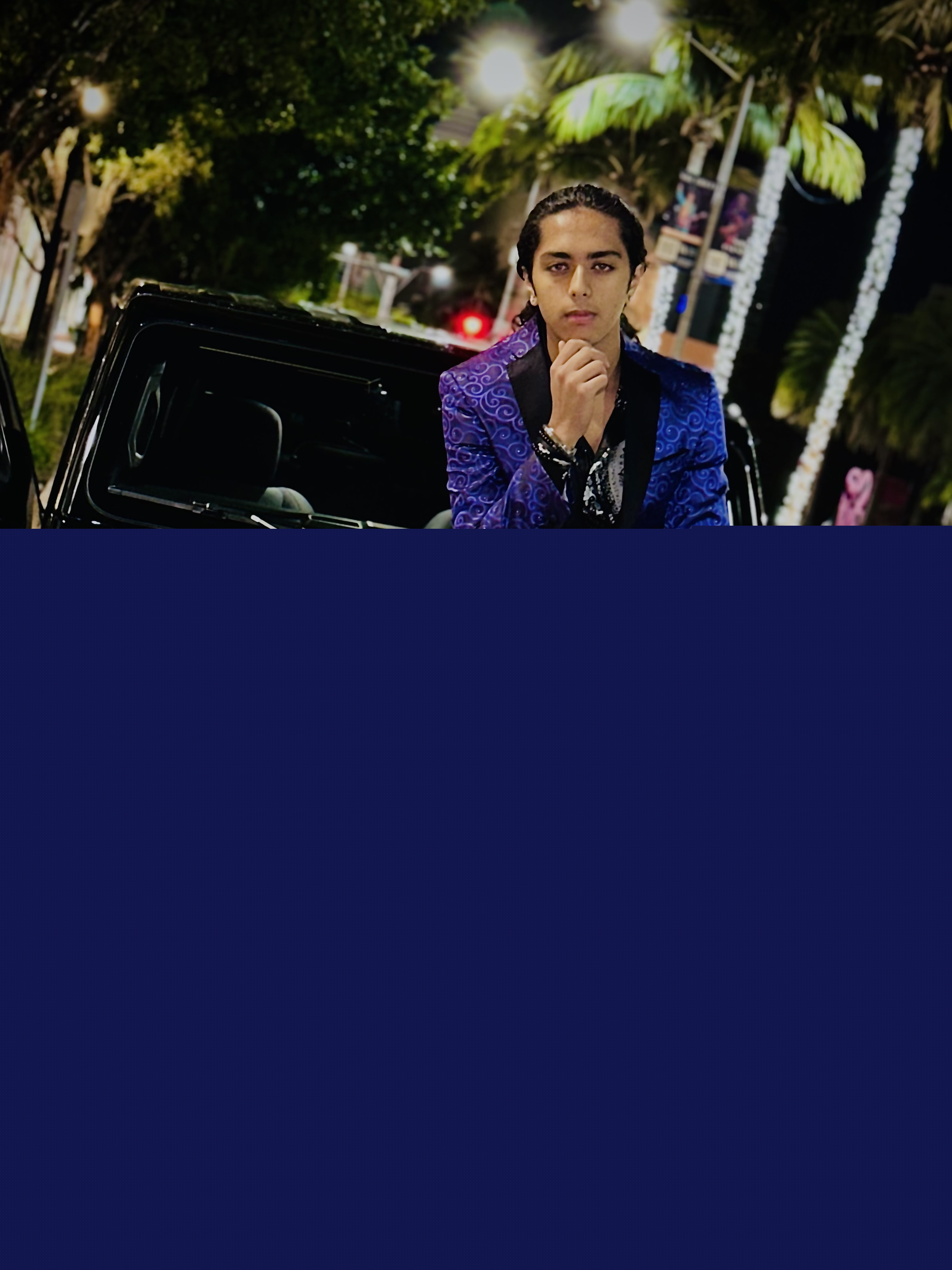 Aryan Rohira casually seated on a jeep for an adventurous shot